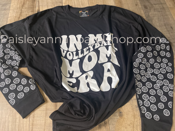 In my volleyball mom era with volleyballs on sleeves long sleeve tee